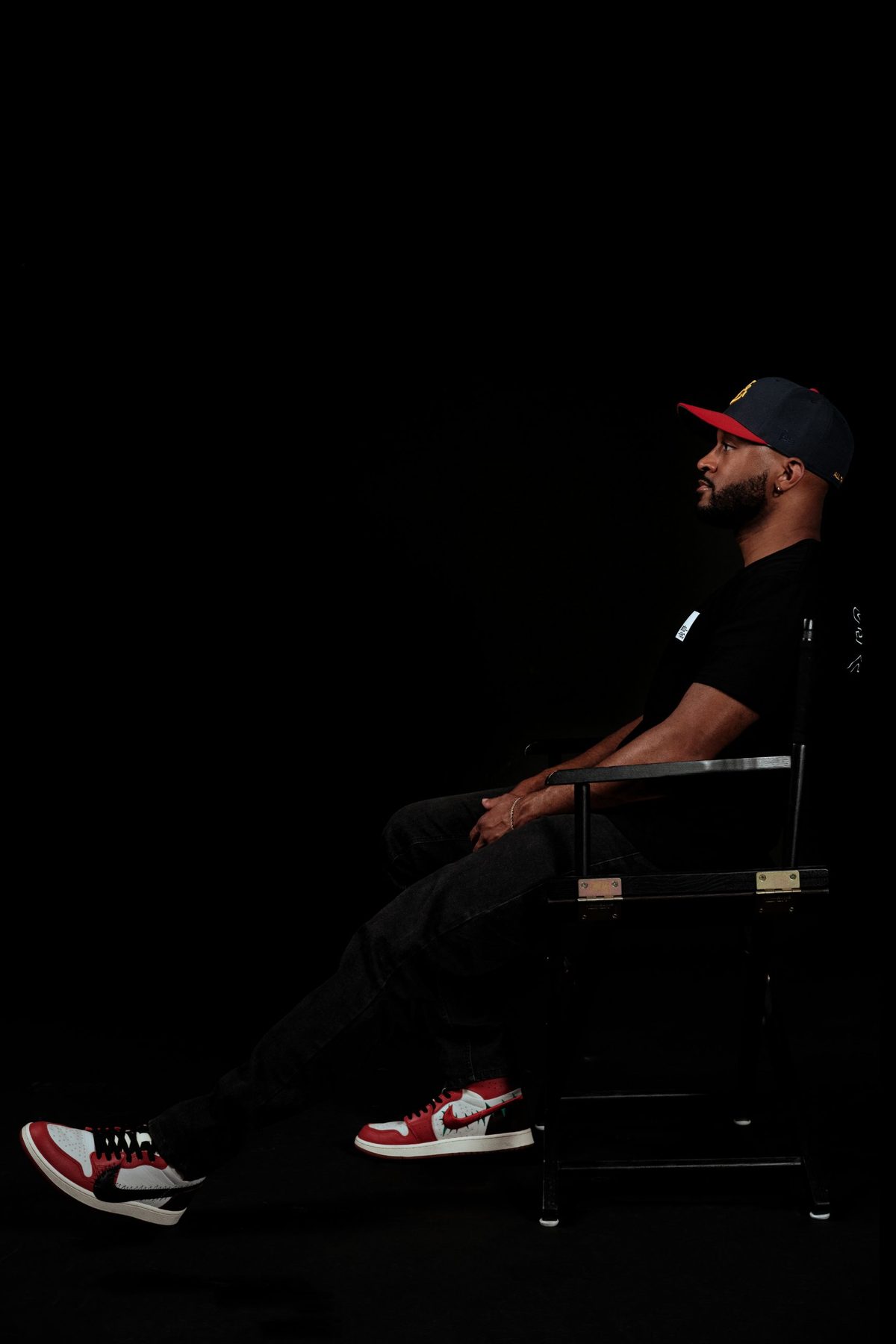 Mason seated in a director's chair