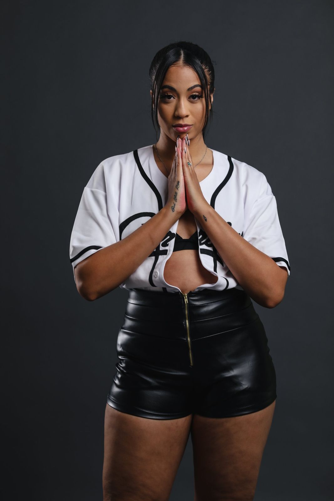 Editorial portrait in a baseball jersey and leather shorts