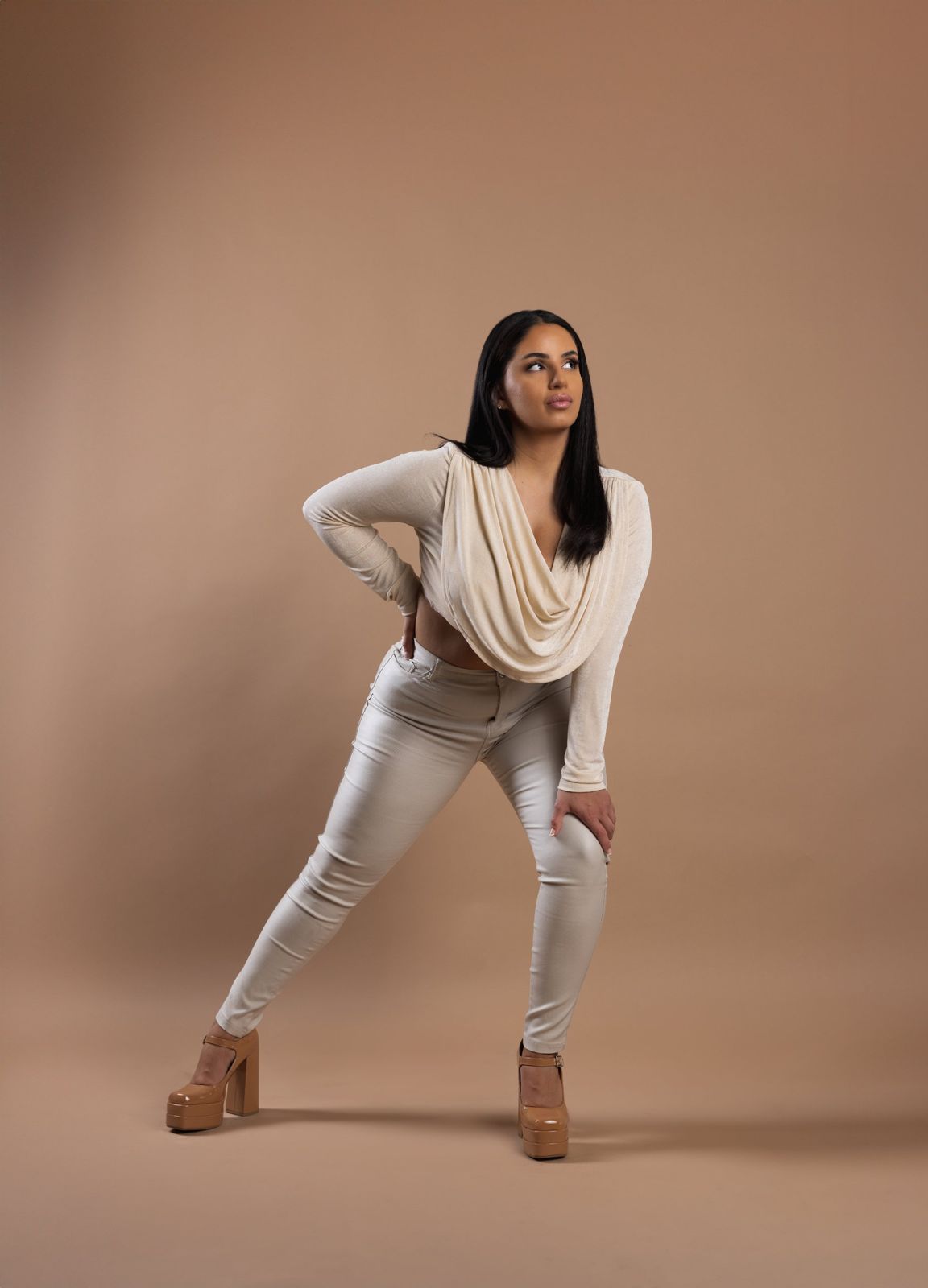 Editorial portrait in a cream draped top