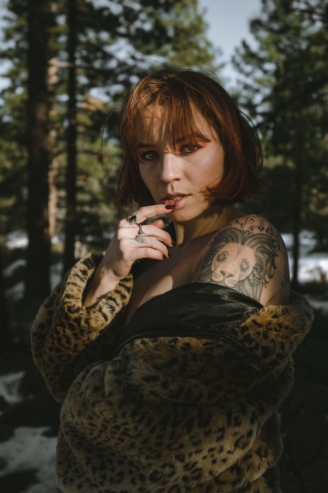Lifestyle portrait in a leopard coat in the woods