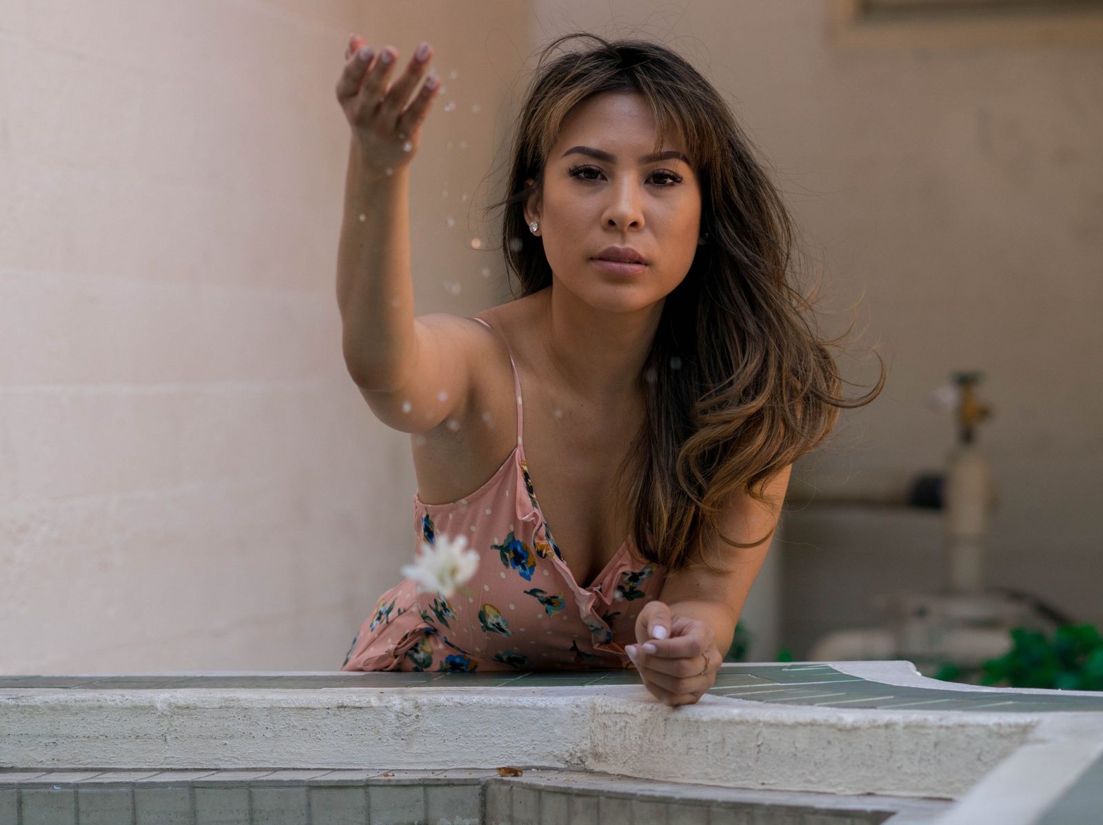 Lifestyle portrait at a fountain edge, tossing water