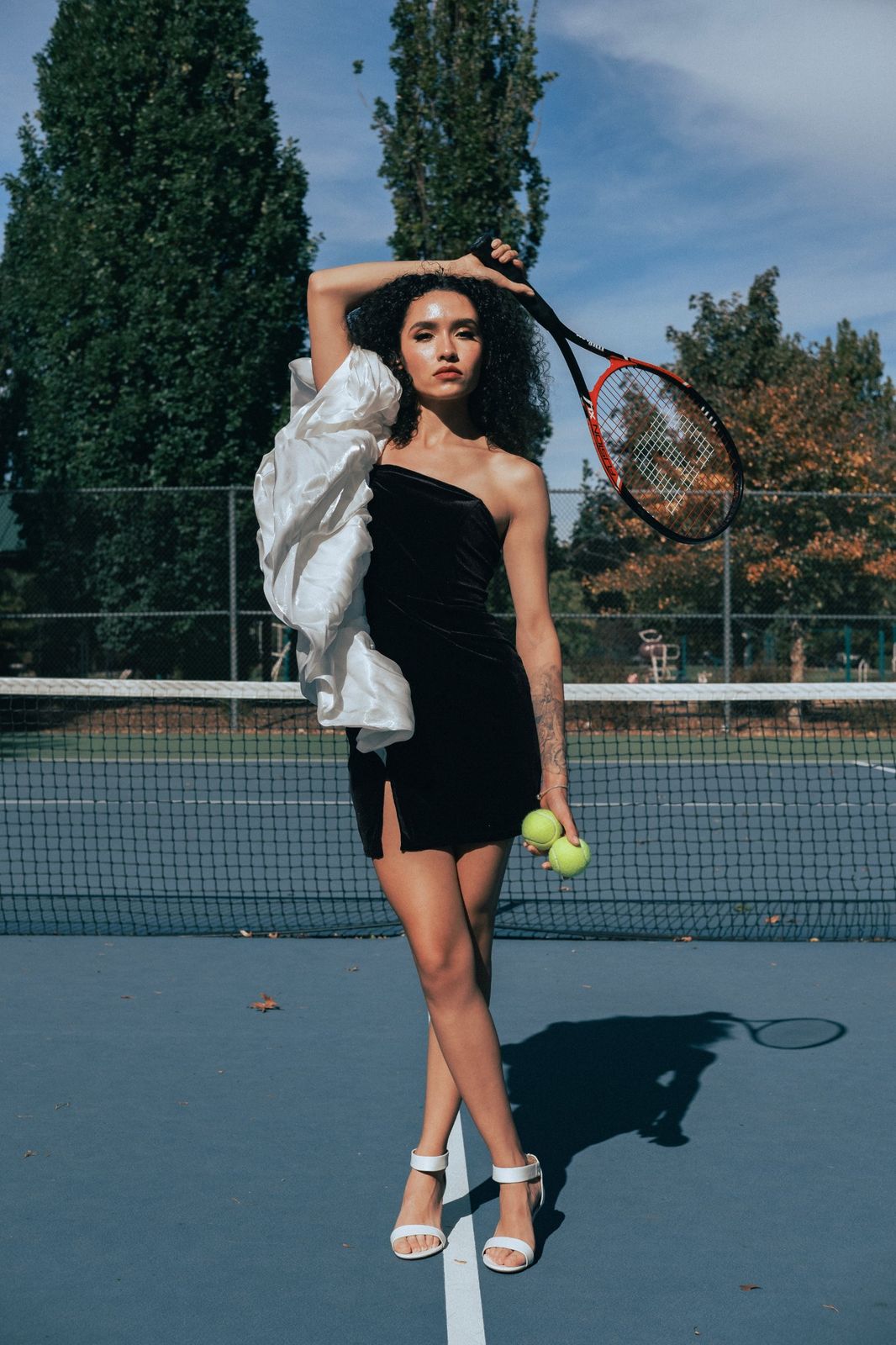Lifestyle portrait on a tennis court with racket and balls