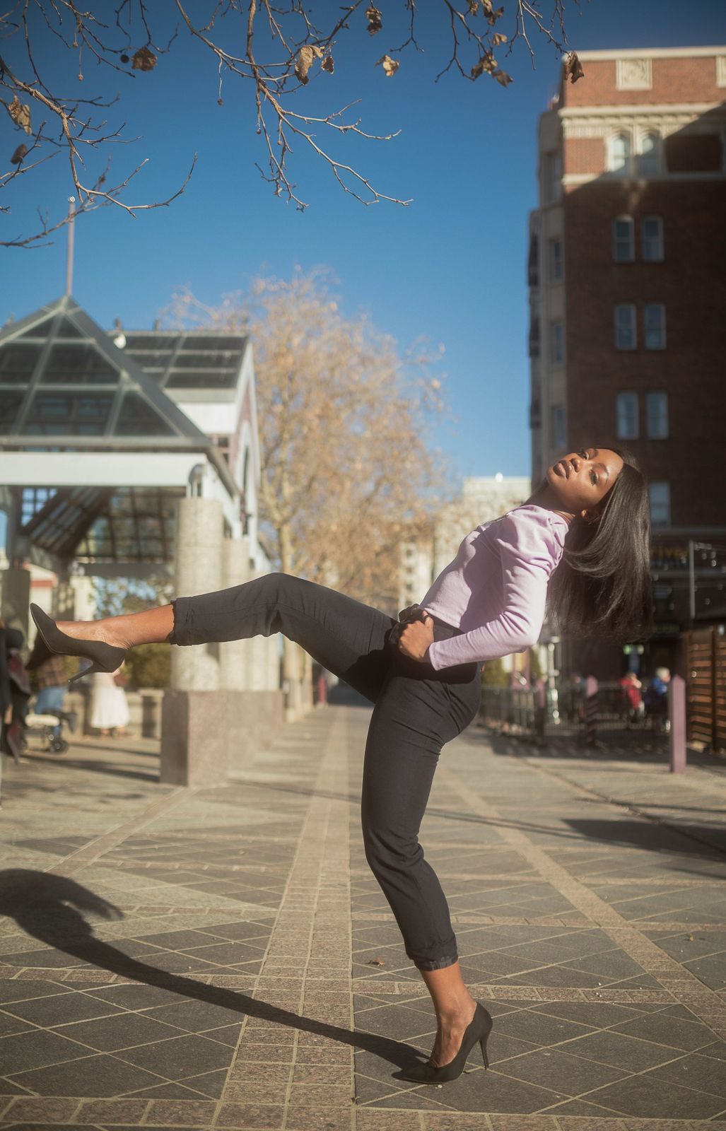 Lifestyle portrait mid-motion on a city sidewalk