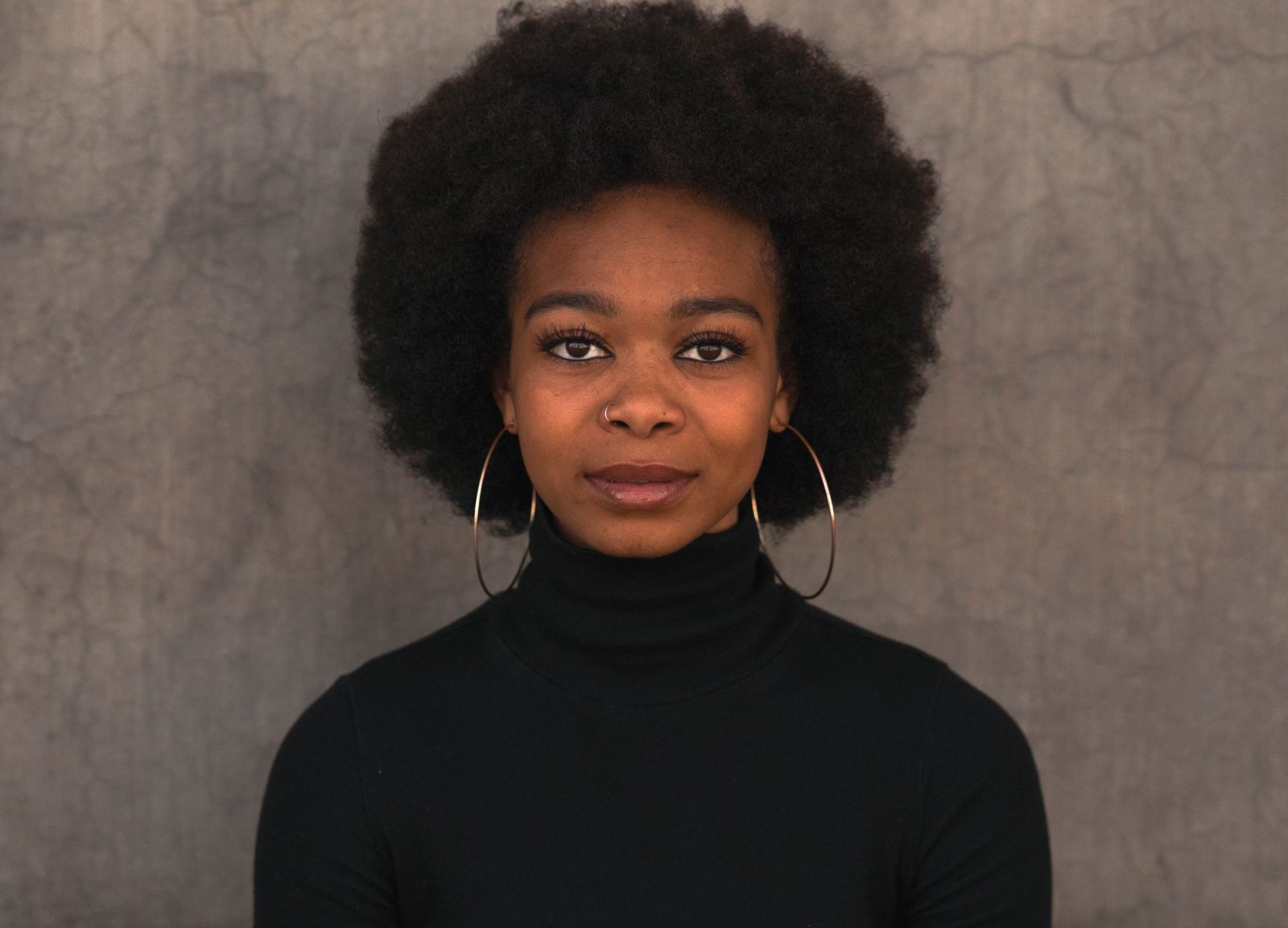 Portrait against a textured grey wall