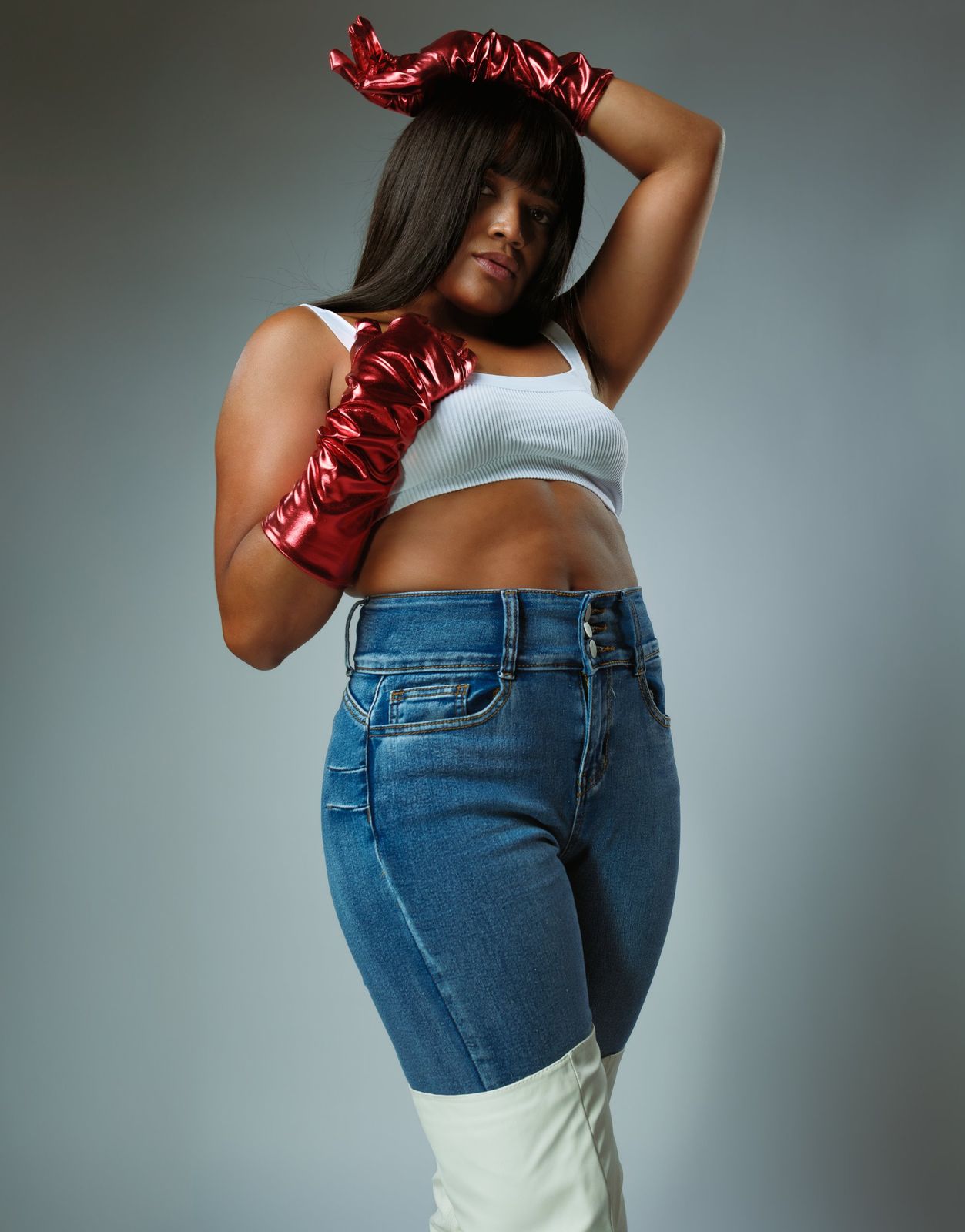 Editorial portrait with metallic red gloves and denim