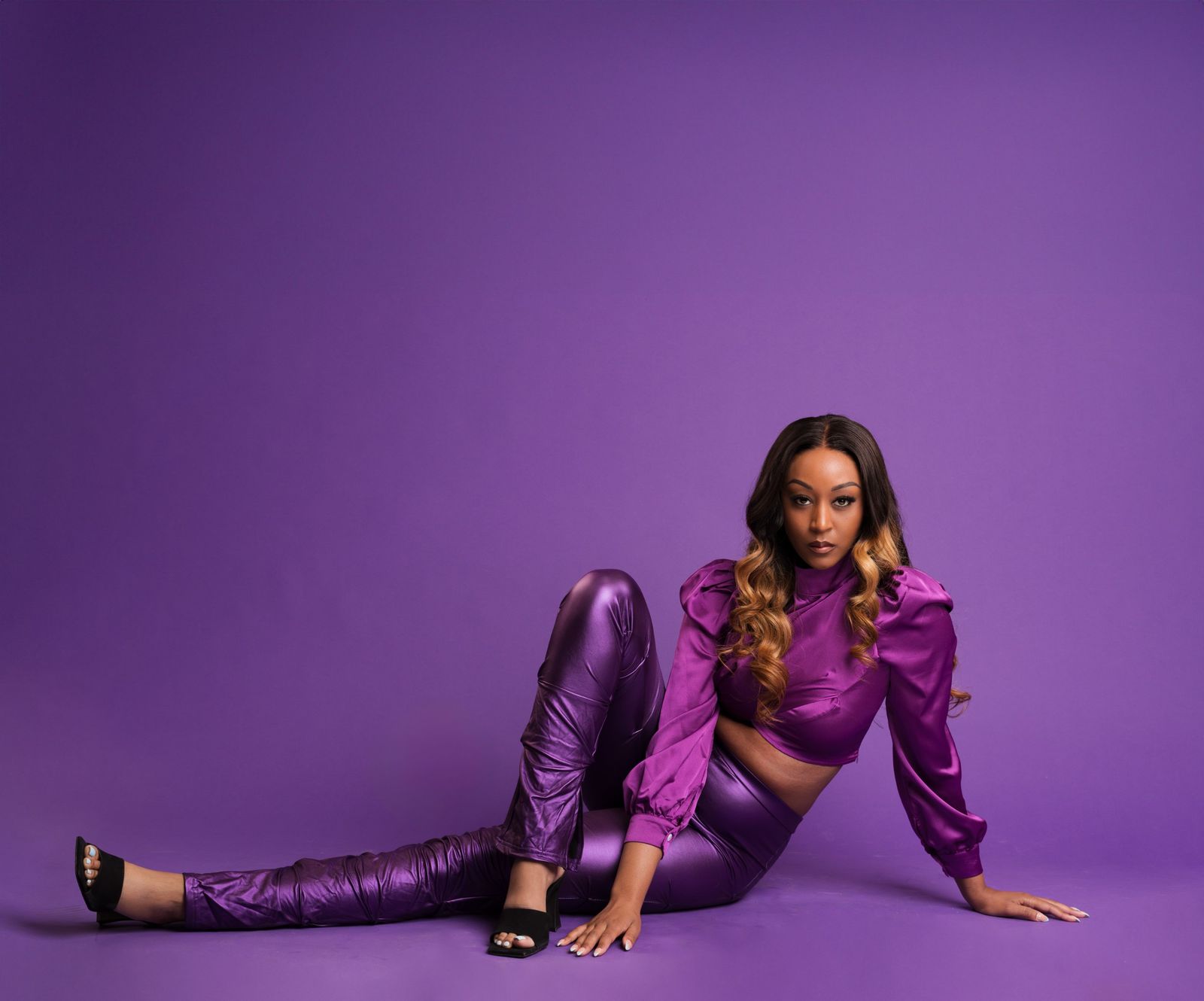 Editorial portrait in purple satin on a purple backdrop